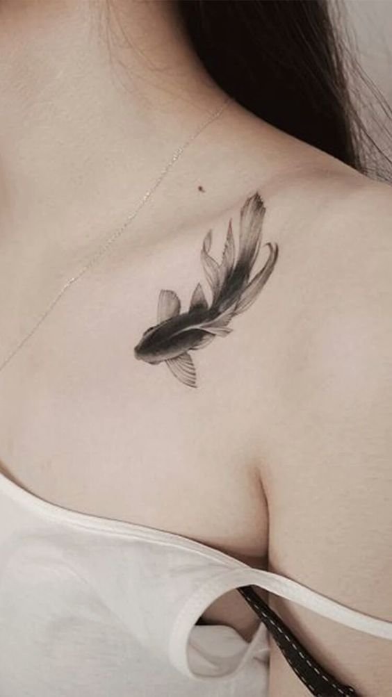 Hình xăm cá trên vai, phong cách blackwork tinh tế, chi tiết rõ nét, độ phân giải HD.