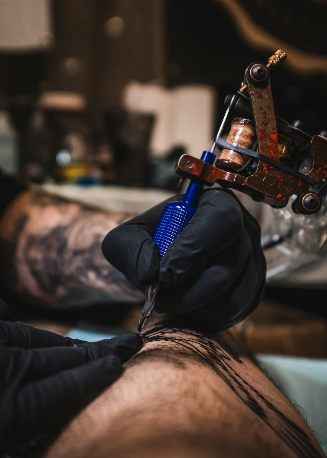 our-journey-02 person-holding-blue-and-brown-tattoo-machine-u4dybd54h88