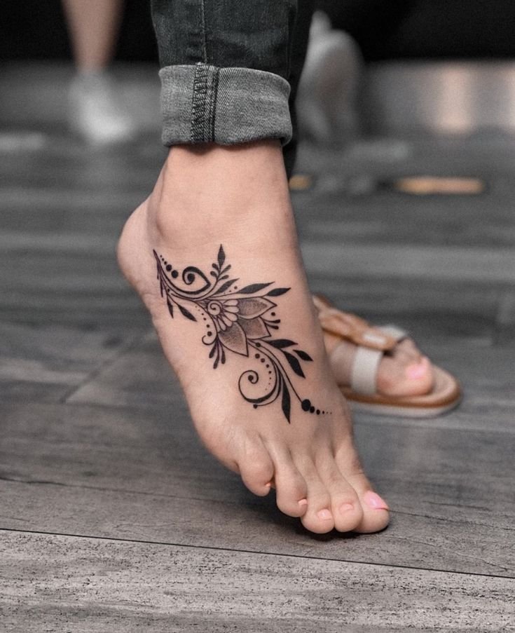 Hình xăm hoa phong cách blackwork trên mu bàn chân, chi tiết sắc nét, ảnh HD.